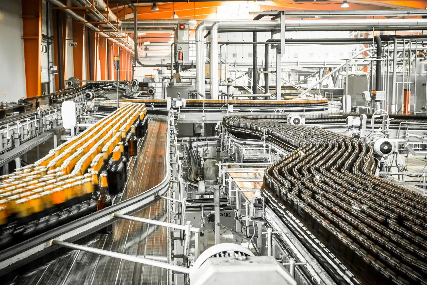 Beverage bottling facility with automated conveyors and processing equipment