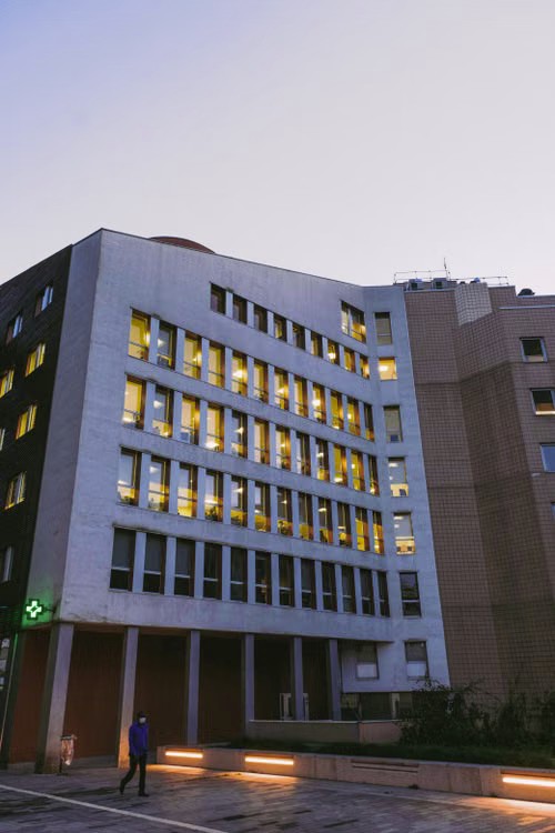 Hospital building lit at dusk