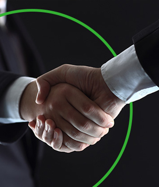Handshake framed by a green circle on a dark background