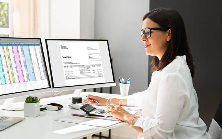 Finance professional reviewing documents at a desk