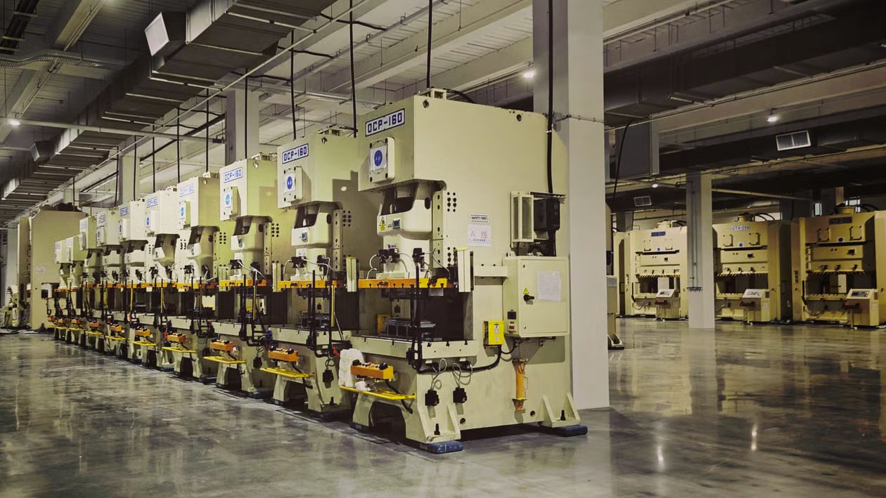 Rows of industrial presses on a factory floor